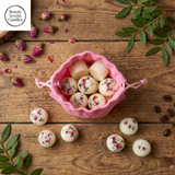 Six Beauty Scents wax melts with red pepper and greens on a rustic wooden table, with a white linen bag and brown tag in the background.